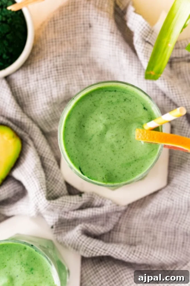 Sunshine Green Smoothie Boost 4 A healthy green smoothie with kale and avocado on a table.