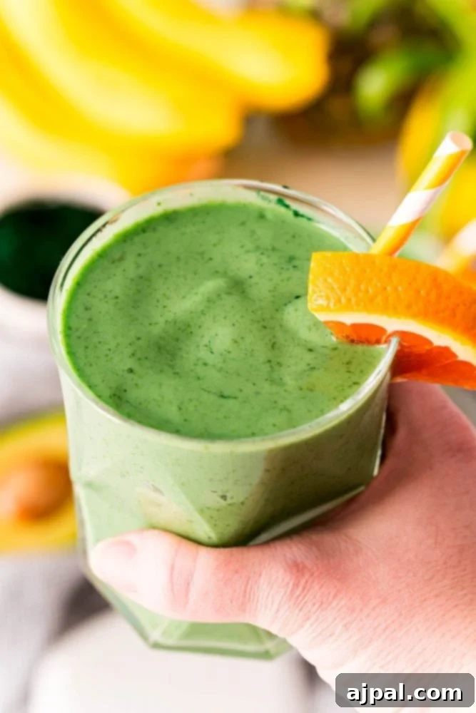 Sunshine Green Smoothie Boost 5 A person holding a healthy green smoothie.