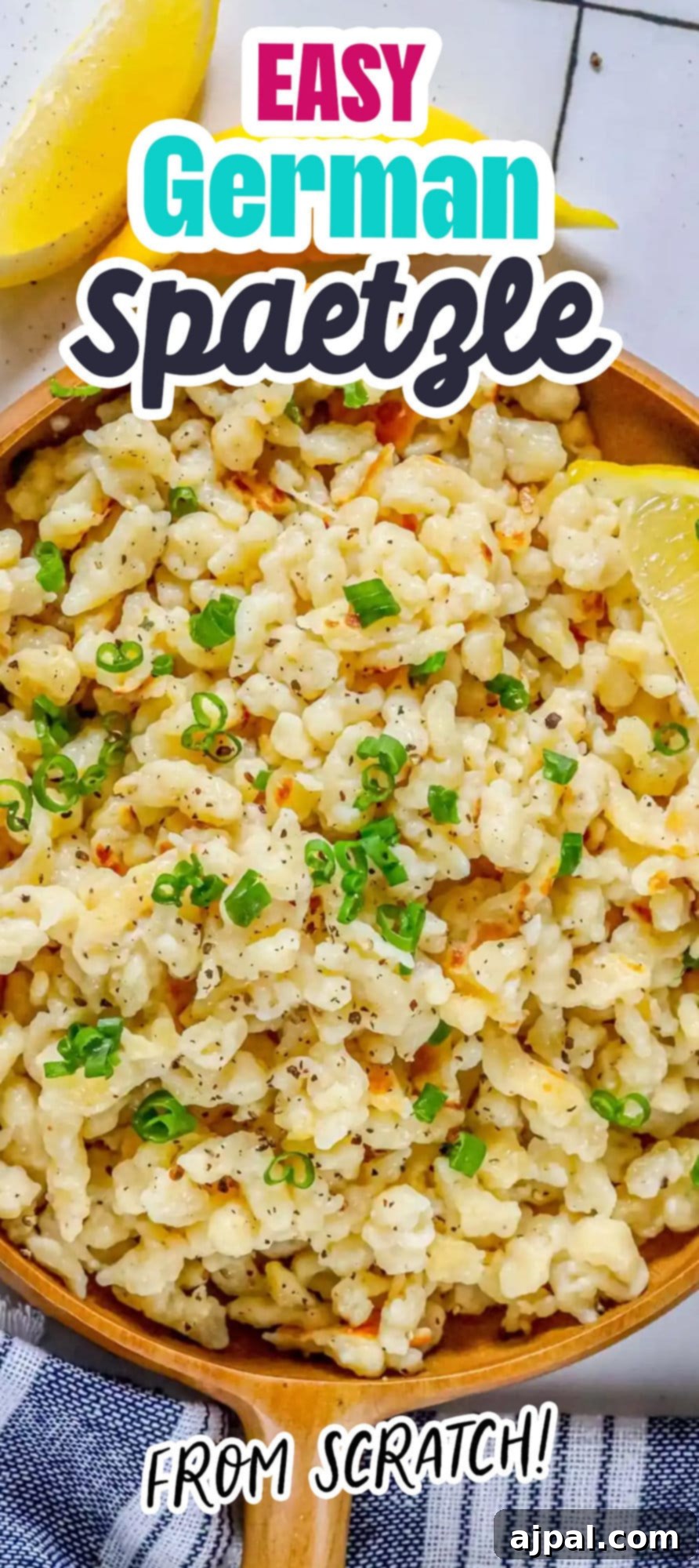 Effortless Homemade Spaetzle 19 spaetzle noodles on a wooden plate with fresh pepper and sliced green onions on top next to a lemon wedge