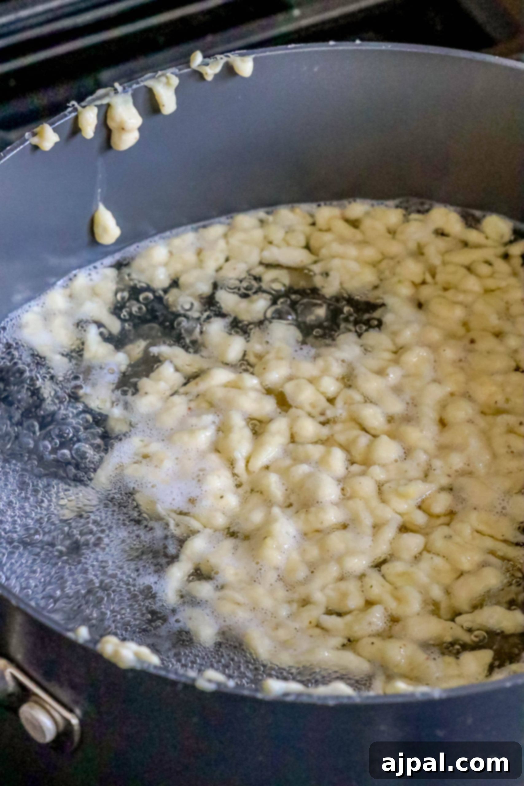 Effortless Homemade Spaetzle 6 spaetzle boiling in a pot of water