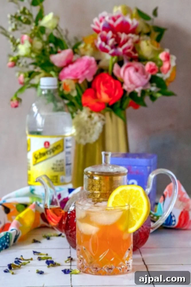 Sparkling Earl Grey Tonic Recipe 6 A close-up of an Earl Grey Sparkling Tea and Tonic mocktail in a tall glass, garnished with a lemon slice, placed on a wooden table, emphasizing its refreshing and inviting appeal.
