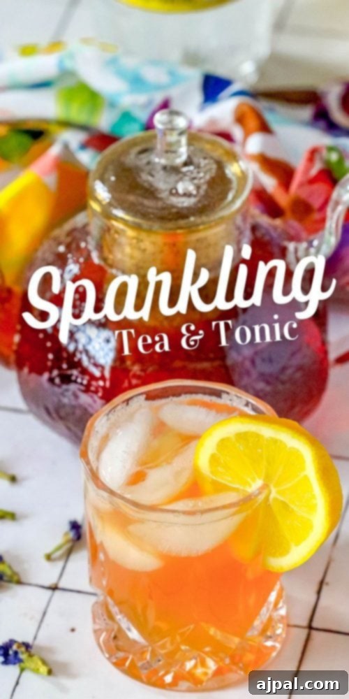 Bubbly Earl Grey Tea Tonic 7 A tall, refreshing glass of Sparkling Tea and Tonic Mocktail, garnished with a lemon slice, against a soft background.