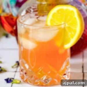Sparkling Earl Grey Tonic Recipe 8 A glass of sparkling tea and tonic with a hint of Earl Grey, garnished with a slice of lemon, showcasing a refreshing and elegant beverage.