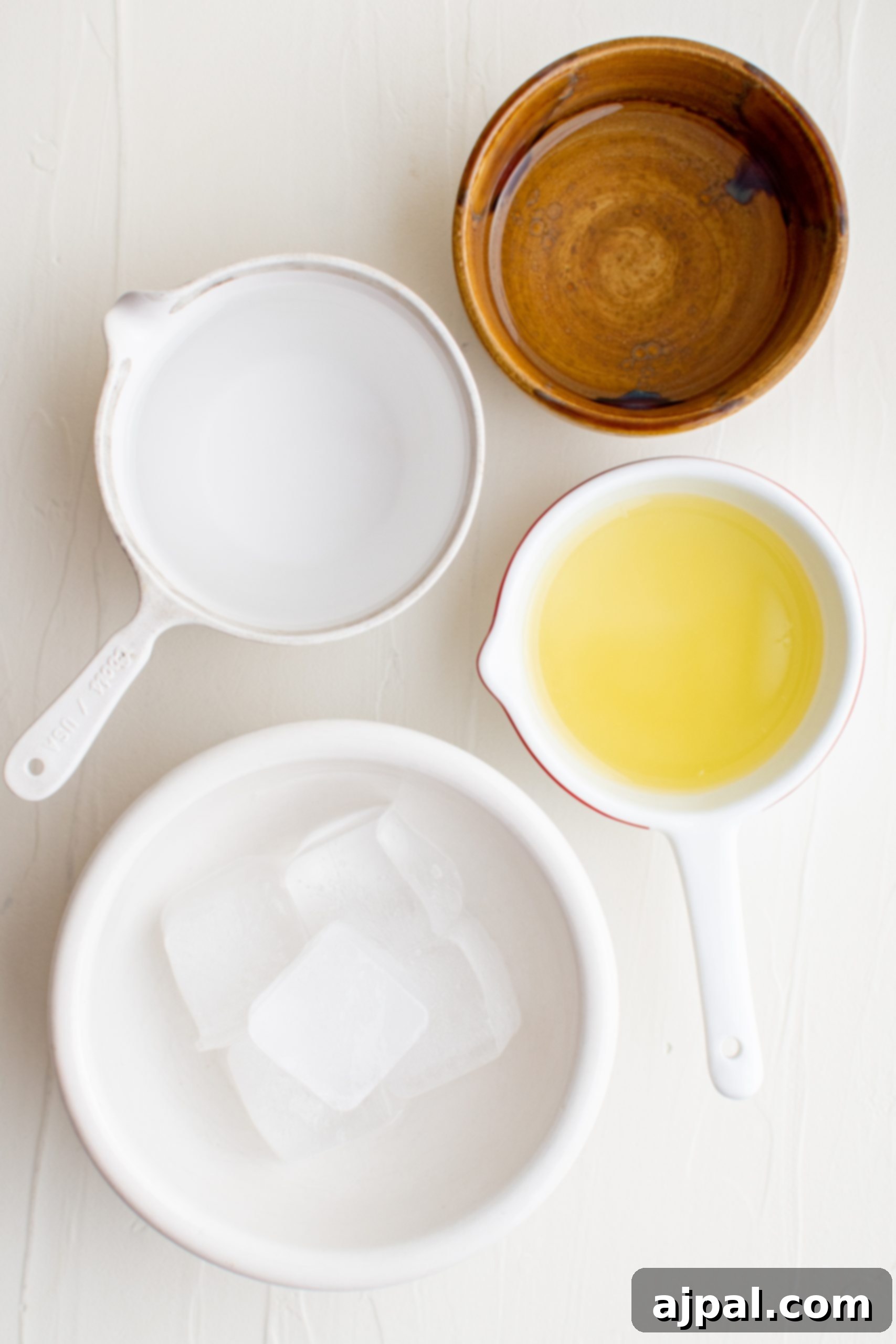 Zesty Lemon Drop Martini Recipe 4 A bowl of oil, a spoon, and a bowl of ice used in making a lemon drop martini.