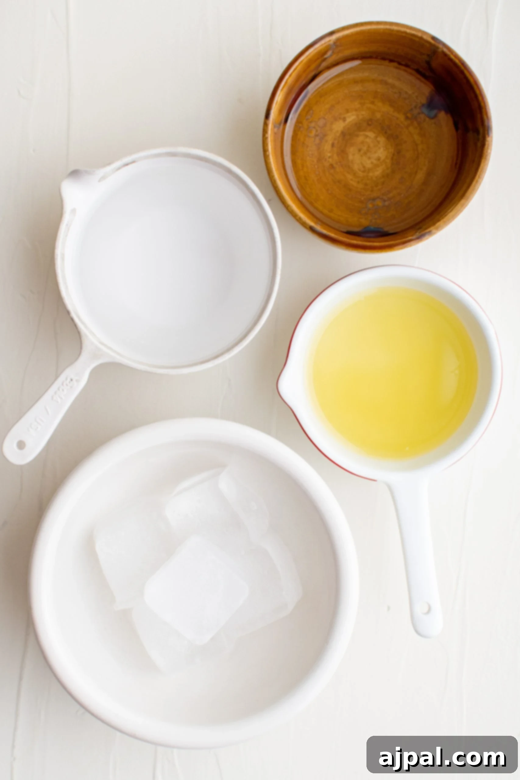 A selection of bar tools and ice, ready for mixing a vibrant Lemon Drop Martini.