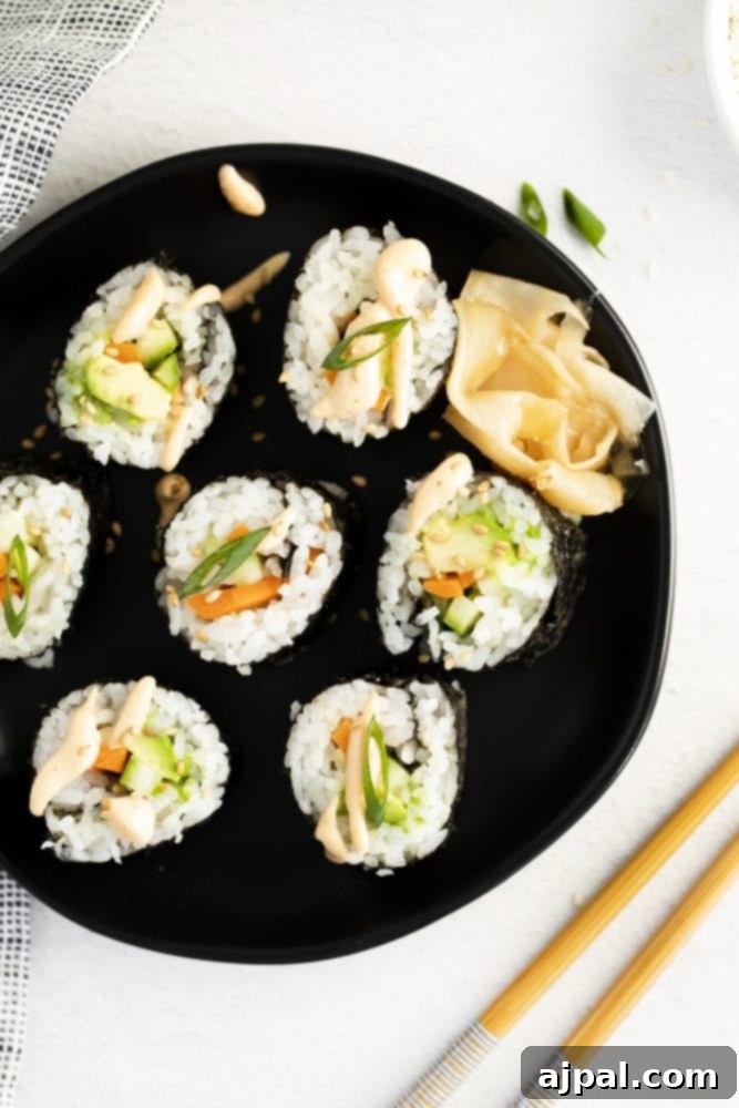 Effortless Vegan Sushi Rolls 2 sushi with rice, avocado, cucumber and carrot with sesame seeds