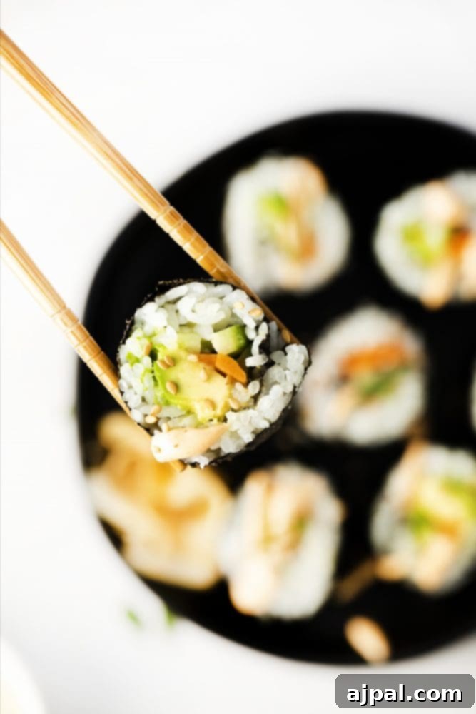 Effortless Vegan Sushi Rolls 7 sushi with rice, avocado, cucumber and carrot with sesame seeds