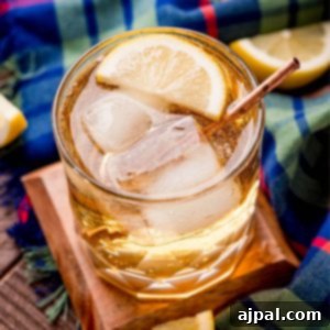 A beautifully presented glass of Scotch and Soda with a slice of lemon and ice, capturing the cocktail's refreshing essence.