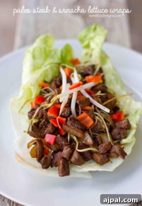 Spicy steak cubes in fresh lettuce cups garnished with pea shoots and chopped bell peppers