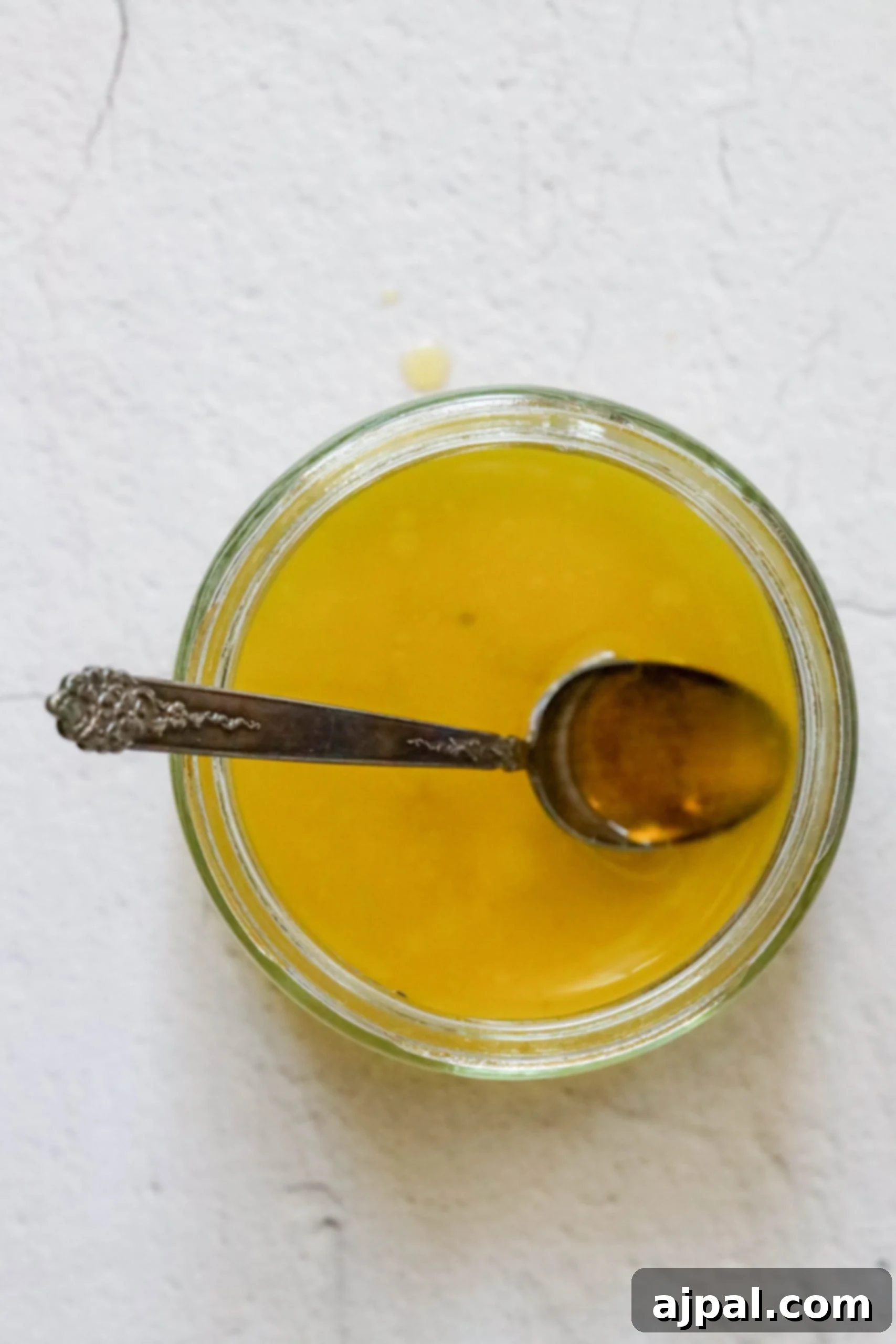 Picture of olive oil and lemon juice in a container, ready to be mixed into the dressing.