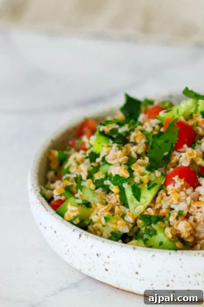 Picture of tabbouleh in a bowl, beautifully garnished and ready to be enjoyed.