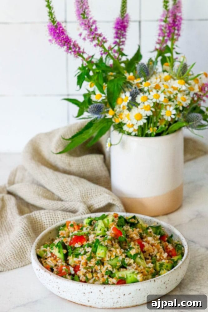 Picture of tabbouleh in a dish on a table in front of wildflowers, highlighting its fresh, natural appeal.