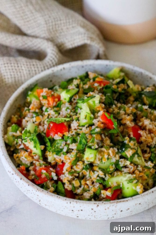 Picture of tabbouleh in a bowl on a table, inviting and fresh.