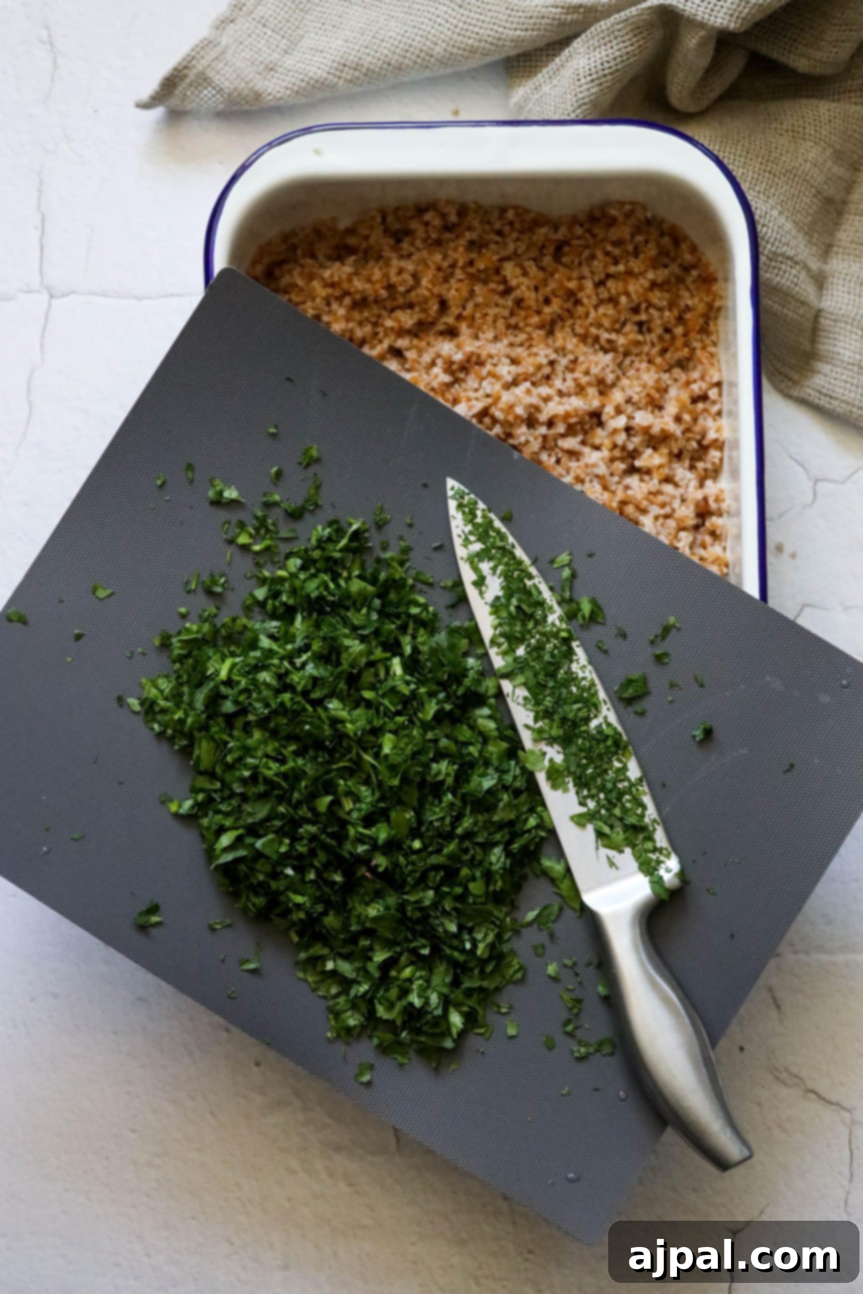 Picture of finely minced parsley on a cutting board, illustrating precise herb preparation.