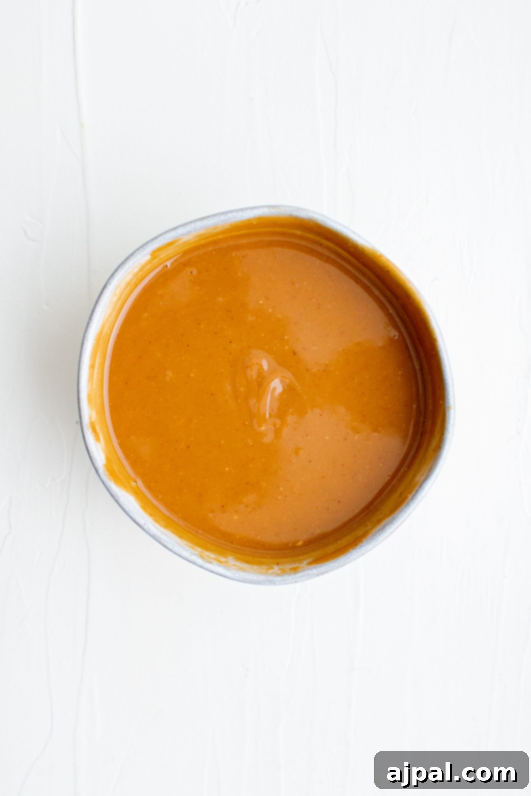 Creamy Peanut Dip in Minutes 6 A vibrant orange dipping sauce for vegan vegetable spring rolls.