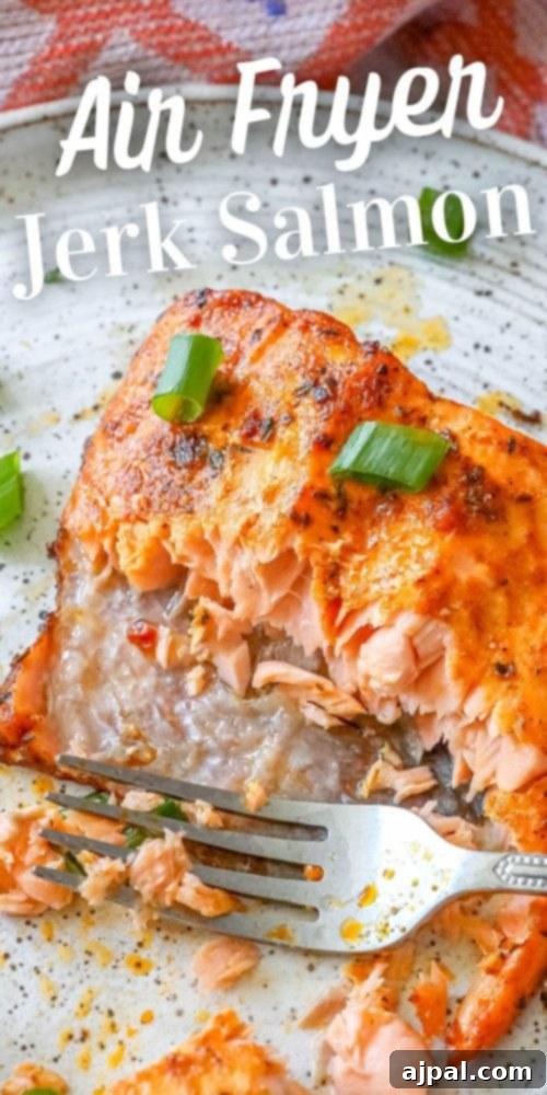 Easy Air Fryer Jerk Salmon 10 A serving of air fryer jerk salmon with green onions and a fork.