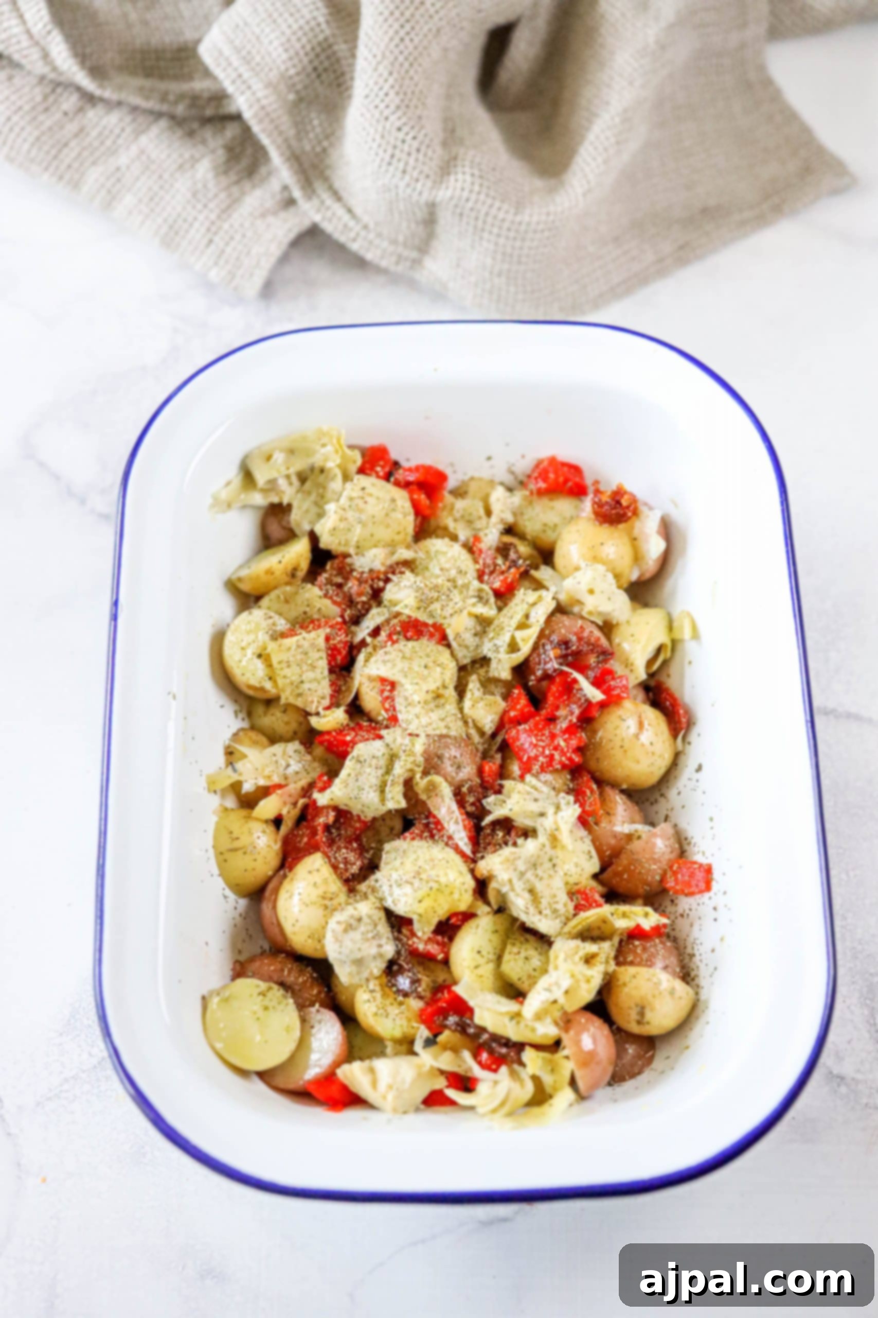 Zesty Italian Potato Salad 7 A delicious medley of potatoes, red pepper strips, and tender artichoke hearts, artfully arranged on a serving platter.