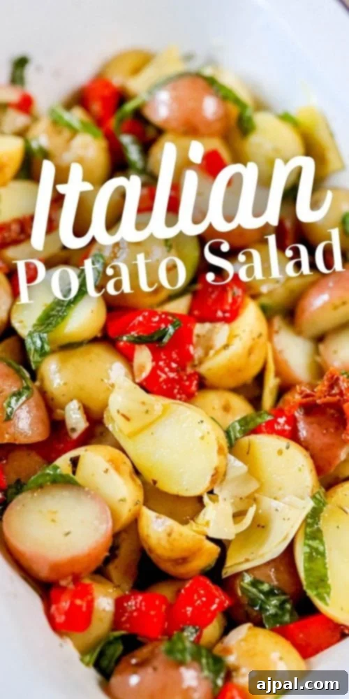 Zesty Italian Potato Salad 10 A beautifully presented Italian potato salad in a clean white dish, featuring tender potatoes, fresh basil, vibrant sun-dried tomatoes, roasted red peppers, and artichoke hearts.