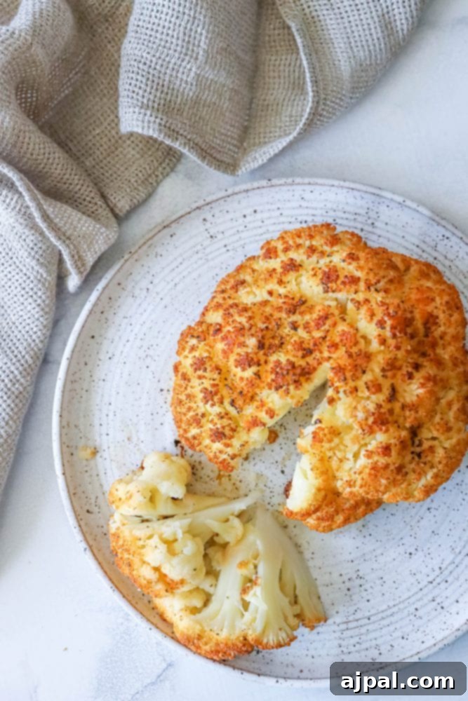 whole roasted cauliflower head on a plate