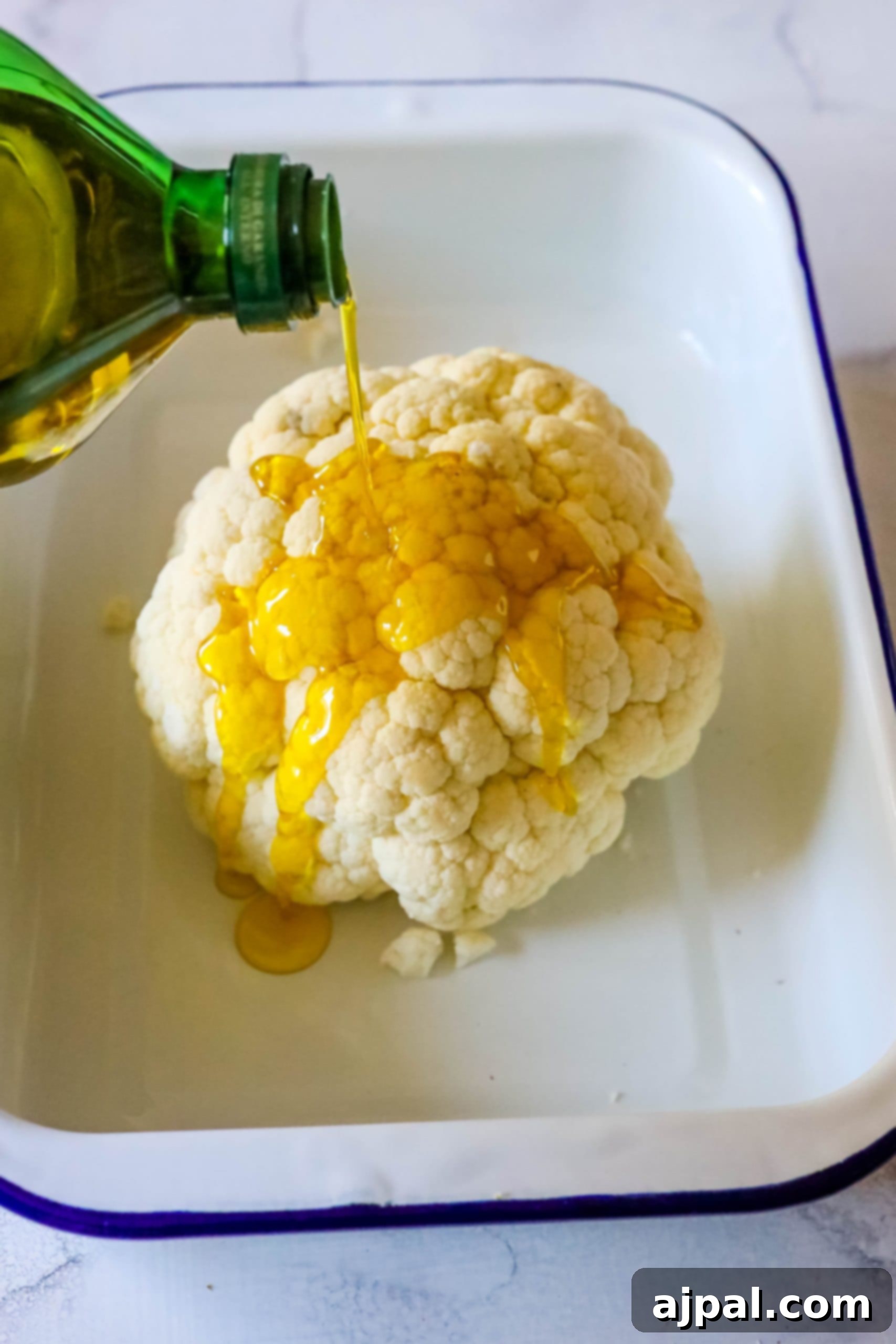 A keto-friendly version of easy roasted cauliflower where the vegetable is drizzled with olive oil.