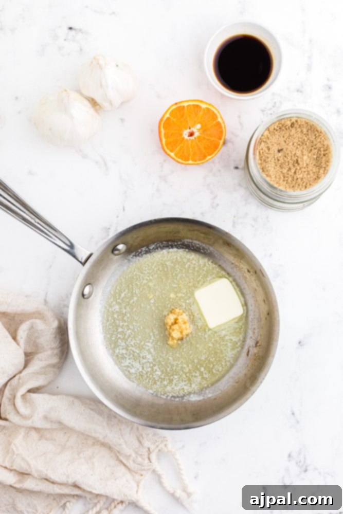 Melted butter and aromatic minced garlic simmering gently in a small pan, forming the foundation of the glaze.