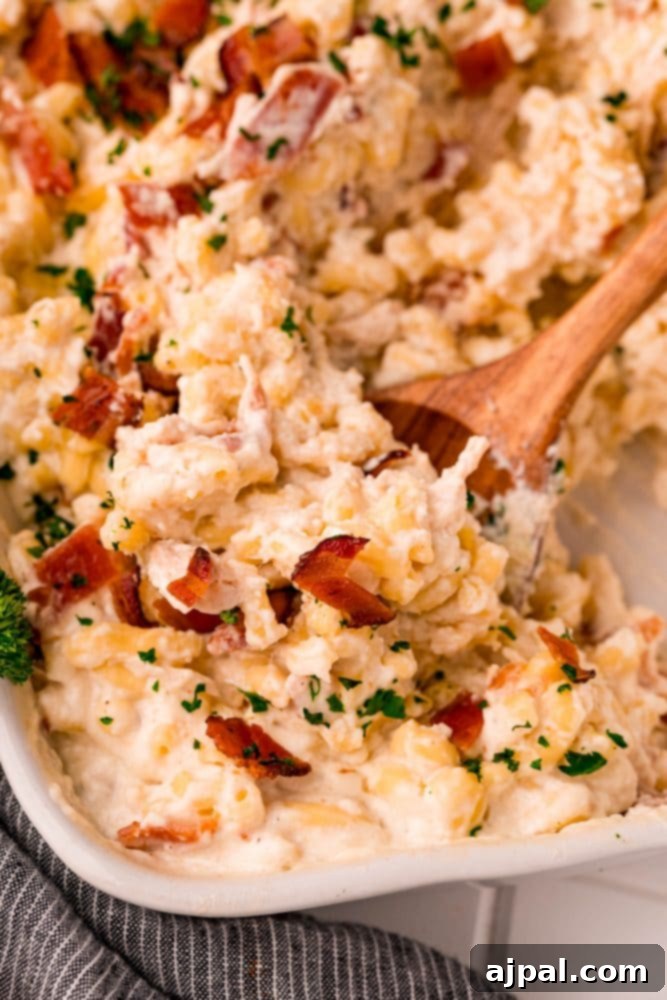 Loaded Bacon Ranch Chicken Mac and Cheese 3 A rich, cheesy casserole dish with golden-brown bacon pieces on top and fresh parsley, ready to serve, highlighting the creamy texture.