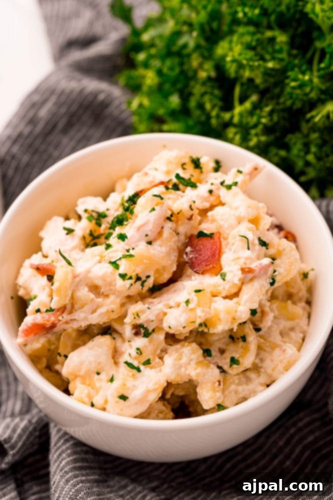 Loaded Bacon Ranch Chicken Mac and Cheese 4 A bowl of creamy pasta featuring chicken, bacon, and a sprinkle of fresh herbs, ready to be enjoyed, highlighting the rich and comforting flavors.