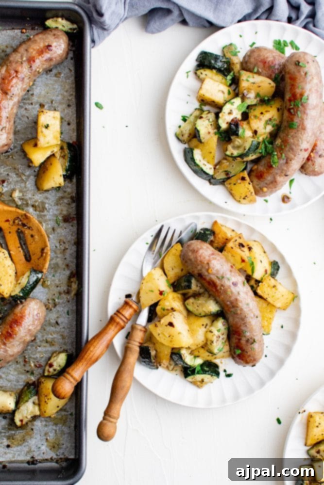 Simple Sheet Pan Sausage Dinner 3 Picture of a serving of sheet pan sausage, potatoes, and zucchini on a white plate, highlighting a delicious meal.