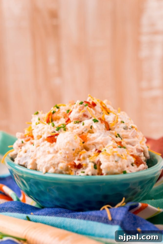 ranch potato salad in a blue bowl on a colorful towel