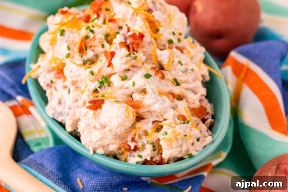 ranch potato salad in a blue bowl on a colorful towel