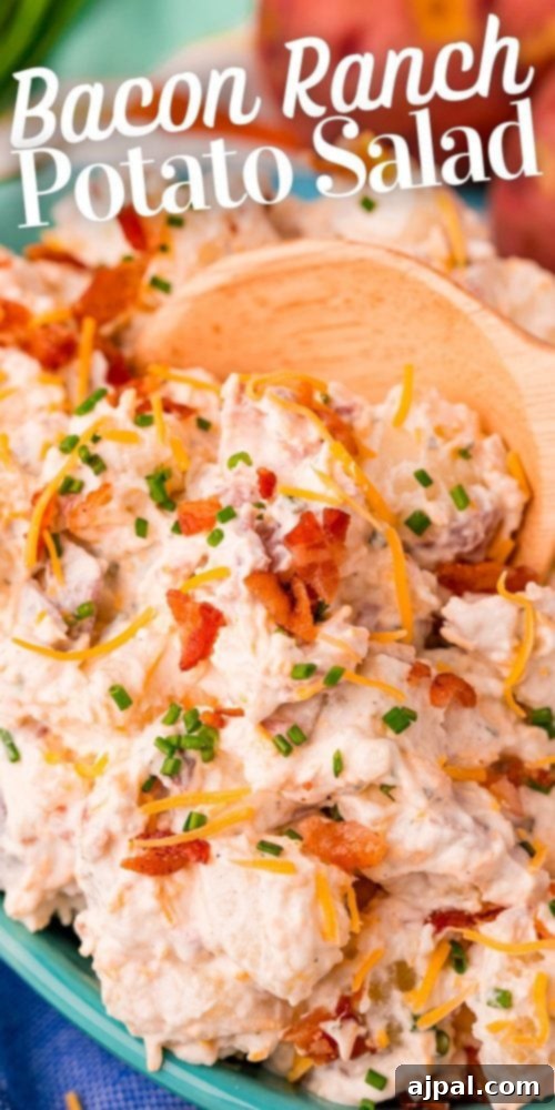 ranch potato salad in a blue bowl on a colorful towel