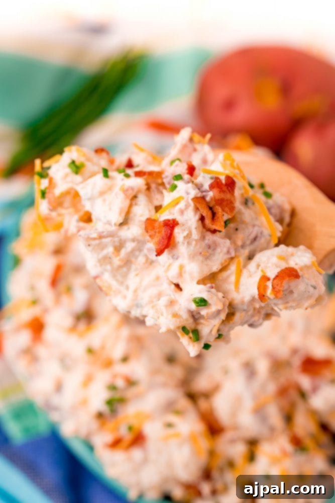 creamy ranch potato salad on wooden spoon