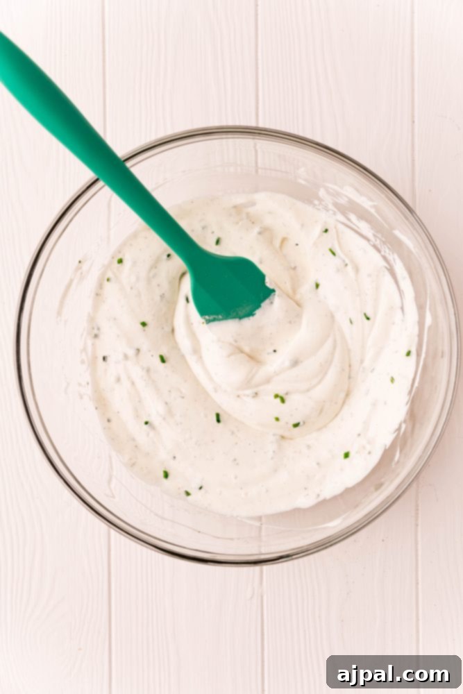 ranch, mayonnaise, chives mixed in a bowl