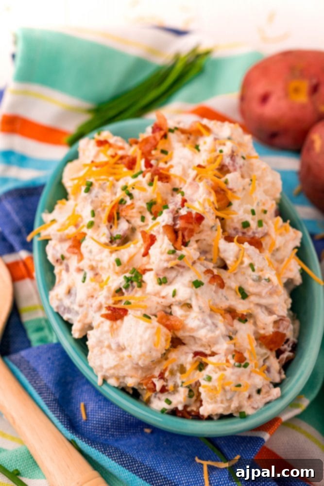 ranch potato salad in a blue bowl on a colorful towel