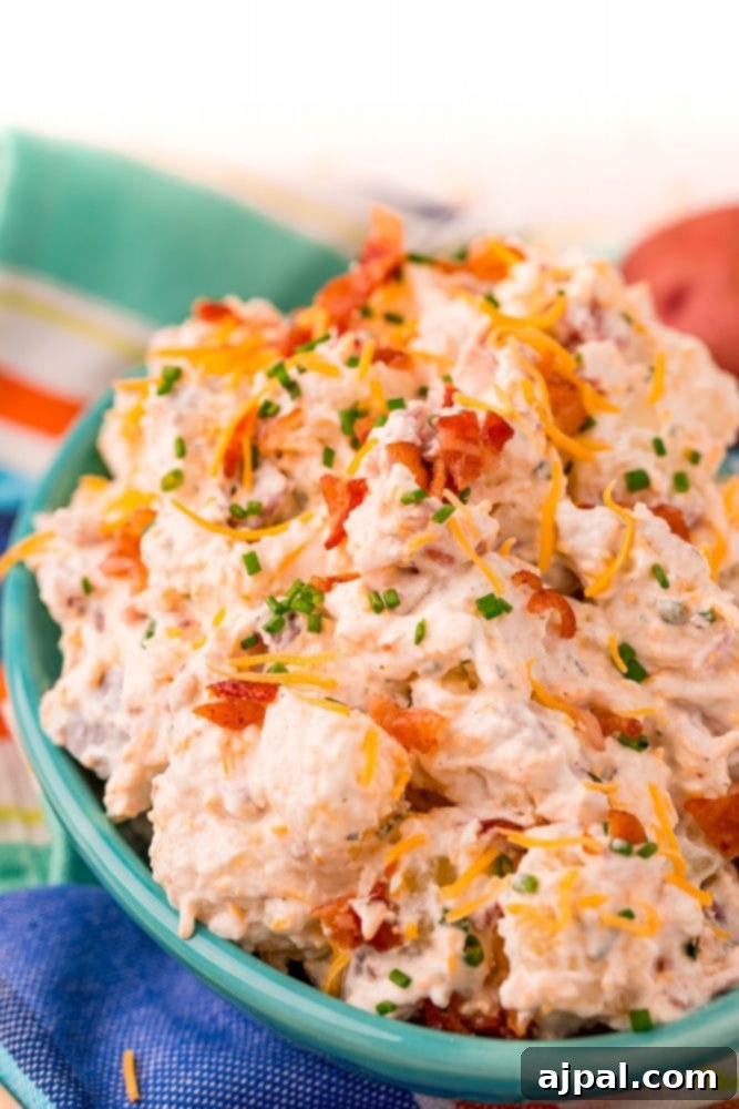 picture of ranch potato salad in a blue bowl on a colorful towel