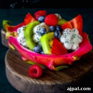 Tropical Dragon Fruit Salad 8 Picture of diced fruit salad in a carved out dragonfruit hull, ready to serve.