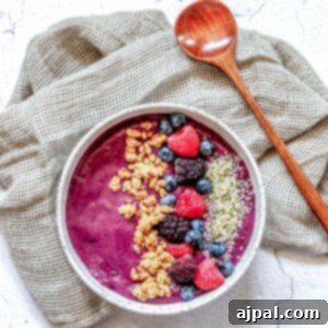 A bowl filled with granola and berries.