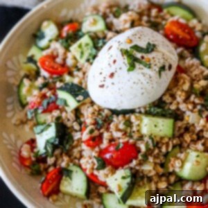 picture of farro salad in a bowl with burrata on top