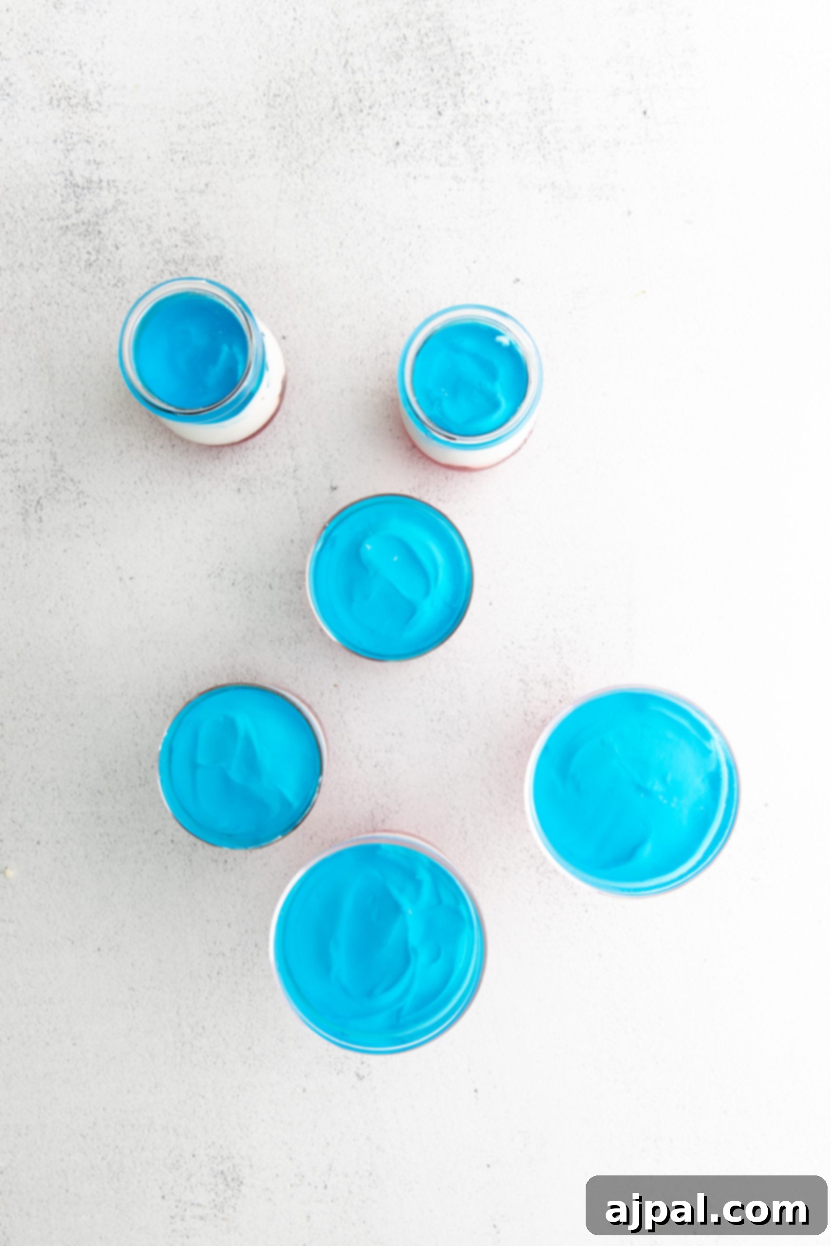 Star-Spangled Jello Cups 10 A group of Fourth of July Jello cups on a white surface.