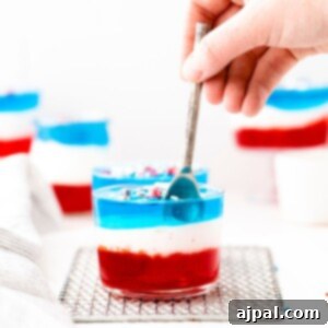 A Fourth of July-themed jello cup recipe featuring red, white, and blue layers.