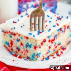 funfetti 4th of july cake iced with buttercream icing and a fork digging in