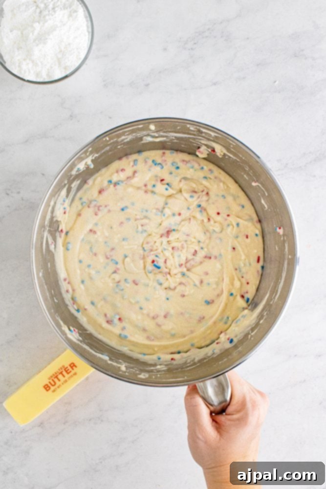red white and blue funfetti cake batter in a bowl