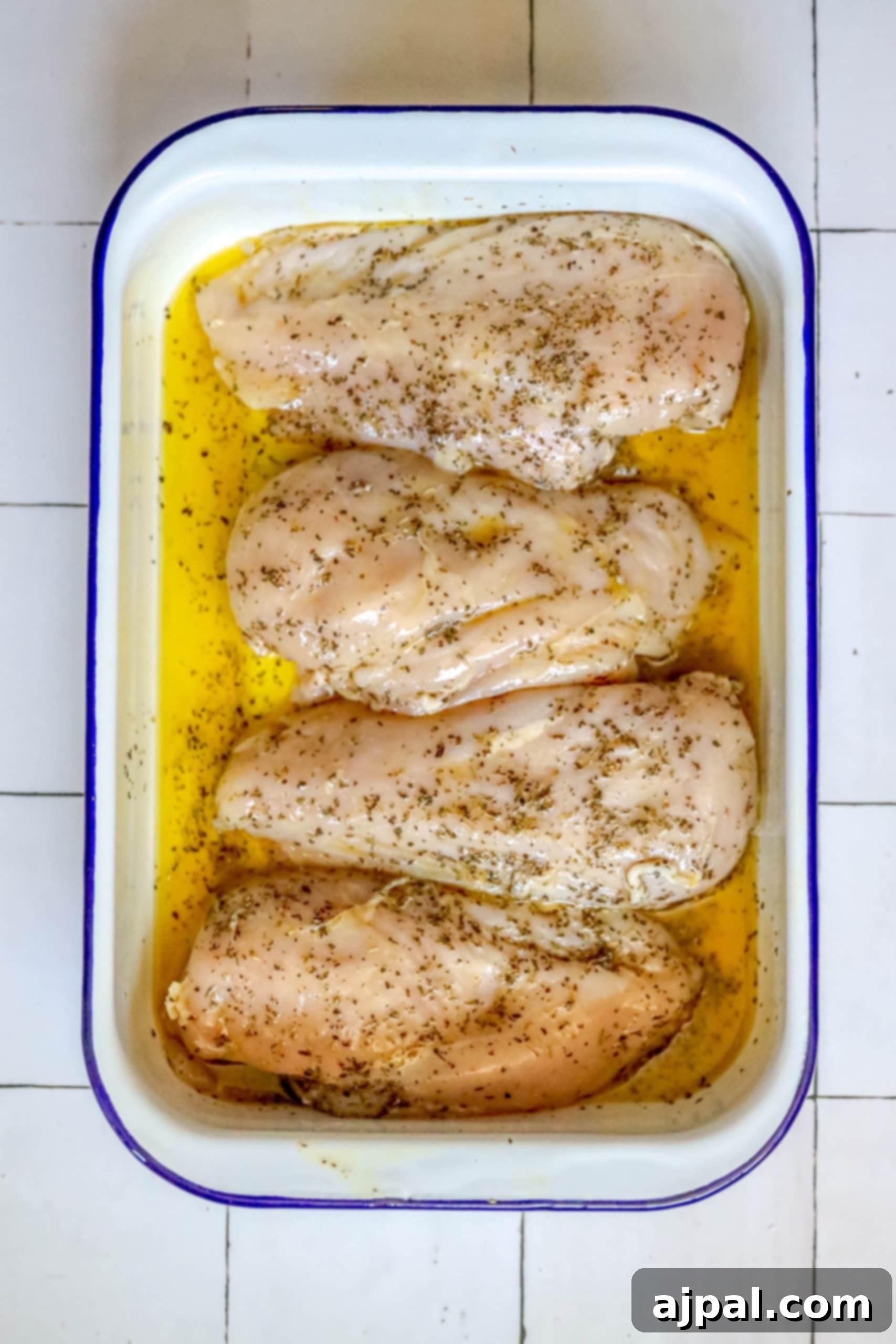 Quick and Easy Garlic Lemon Baked Chicken Breasts 4 Chicken breasts in a baking dish with lemon and garlic.