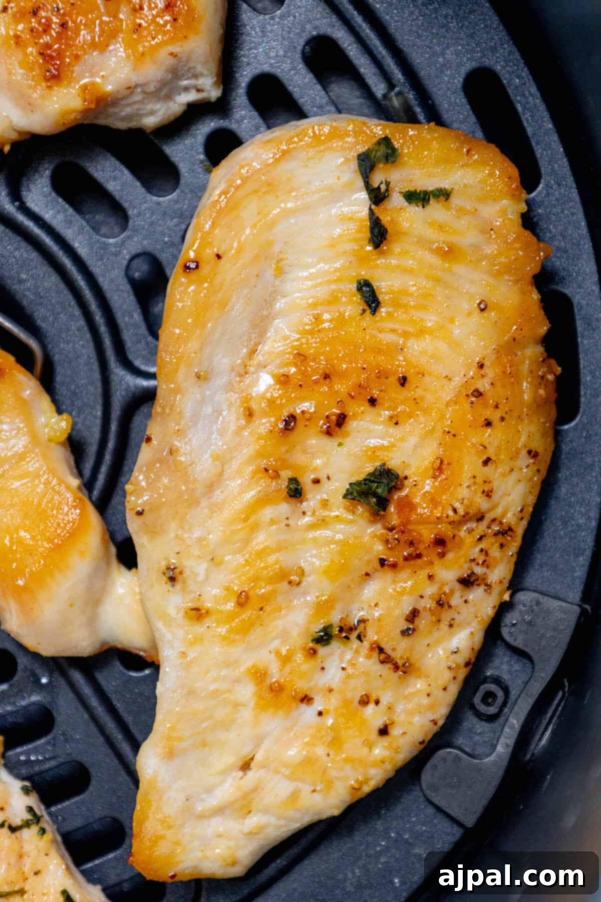 Air-fryer chicken breasts. A basket full of golden-brown air-fried chicken breasts.