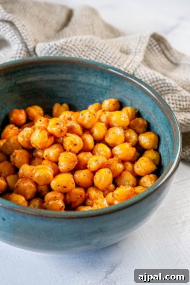Zesty Air Fried Chickpea Crunch 3 Air fried lemon pepper chickpeas in a vibrant blue bowl.