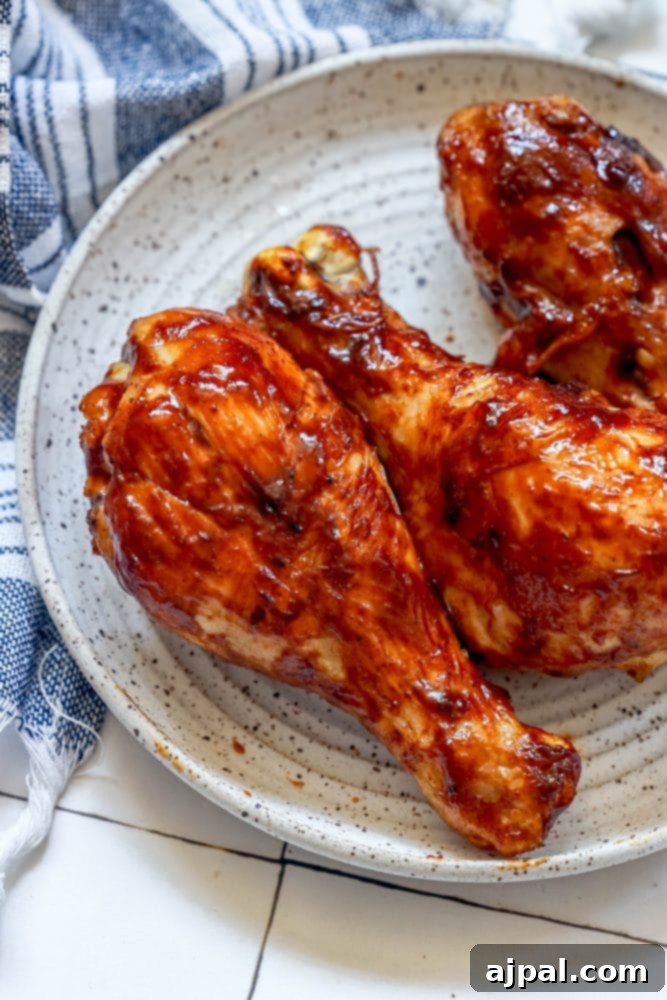 Ultimate Crispy Air Fryer BBQ Drumsticks 4 Air fried BBQ chicken drumsticks artfully arranged on a white plate