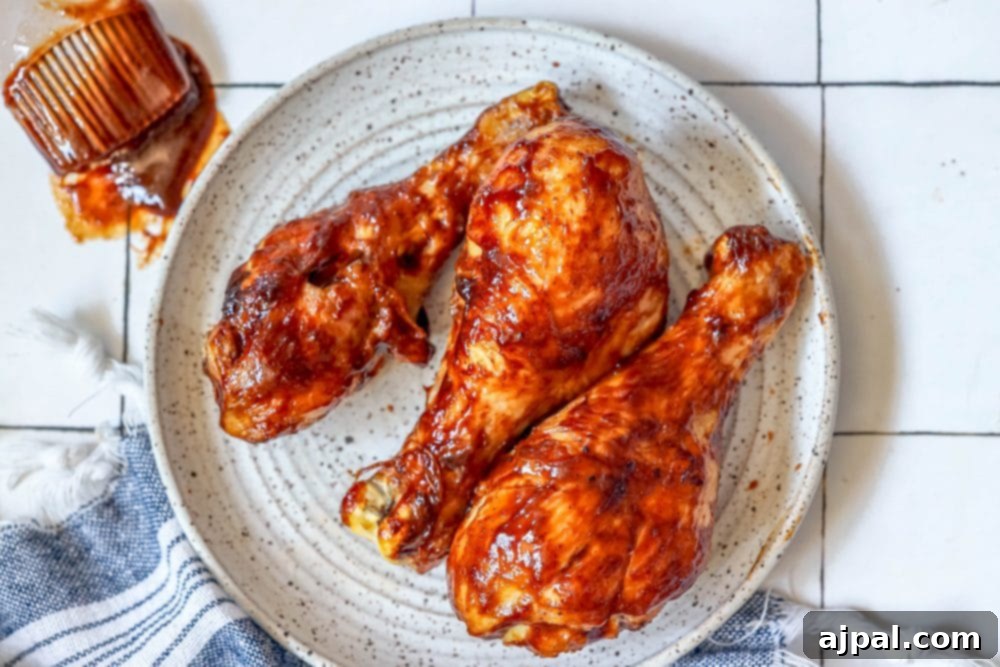 Ultimate Crispy Air Fryer BBQ Drumsticks 6 Air Fried BBQ Chicken Drumsticks on a white plate, glistening with sauce and ready to eat