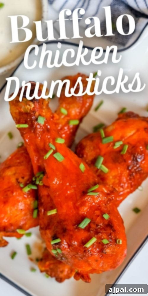Ultimate Crispy Buffalo Drumsticks 10 A plate piled high with crunchy buffalo chicken drumsticks, glistening with spicy sauce.