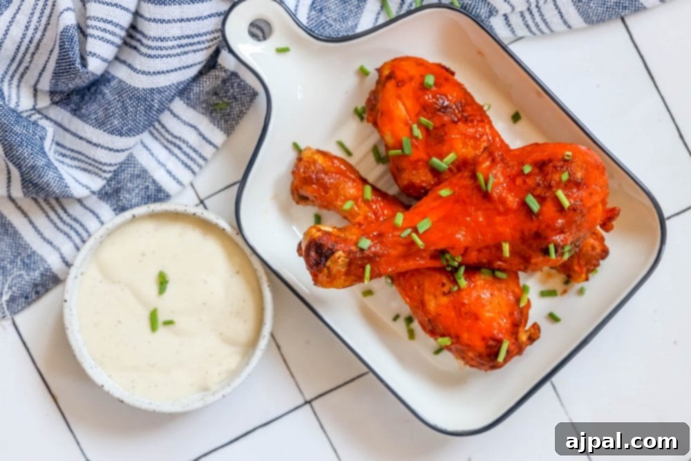 Ultimate Crispy Buffalo Drumsticks 7 Crispy baked buffalo chicken legs, gleaming with spicy sauce, served with a side of creamy dip.