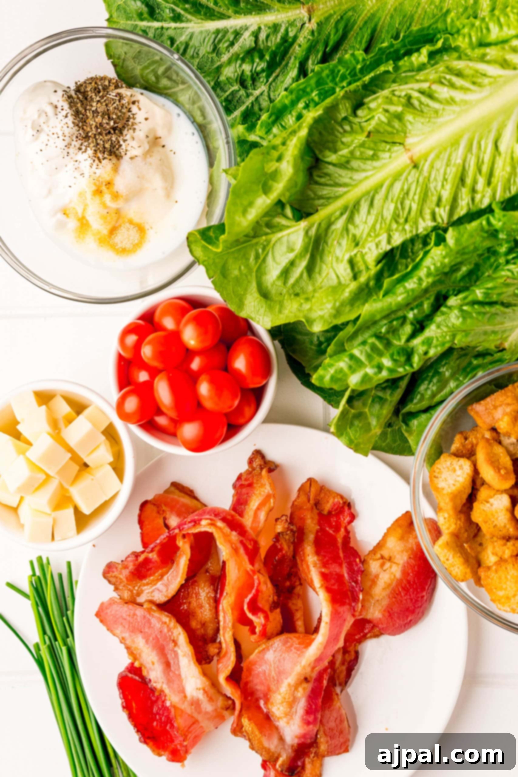 Effortless BLT Salad 5 A plate with bacon, lettuce, tomatoes and a creamy dressing.